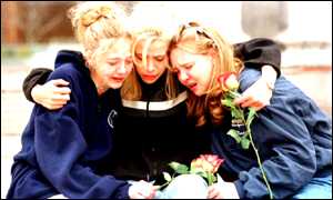 Columbine School friends of the shooting victims comfort each other during a memorial service